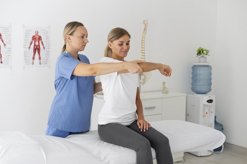 A physiotherapist guiding a patient through an exercise with resistance bands in a well-equipped therapy clinic.